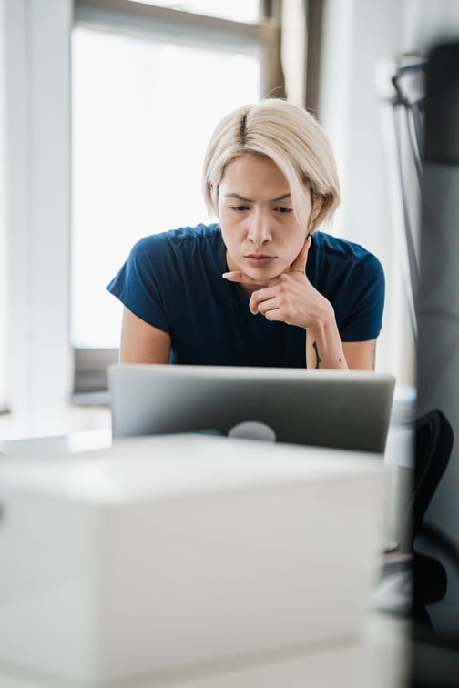 Consultant focused on a laptop screen